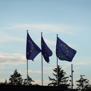 Image of three EU flags in the wind