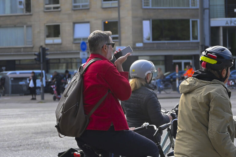 Fietser gebruikt gsm op de fiets